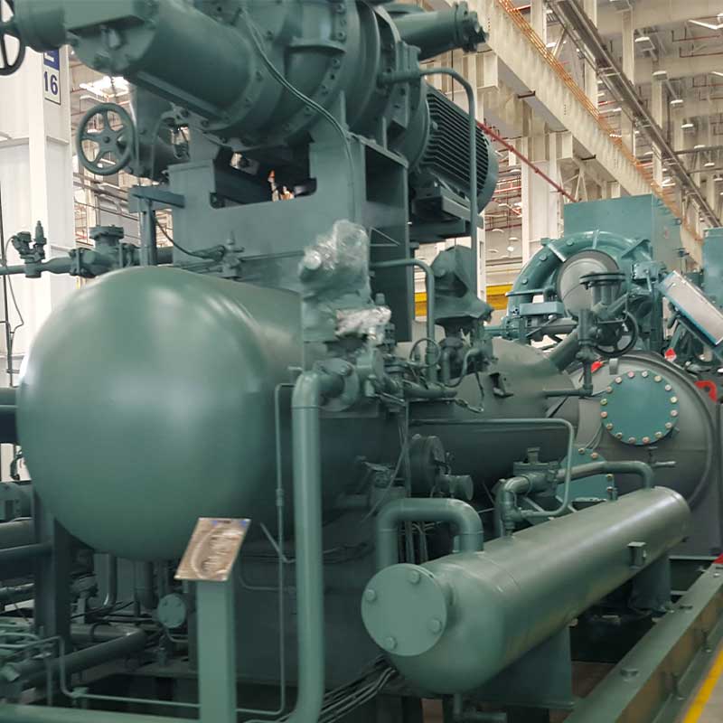 person using crane to move industrial gear box in engineering factory