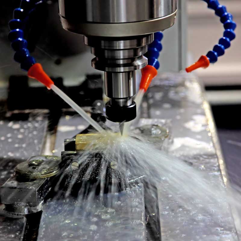 person using crane to move industrial gear box in engineering factory