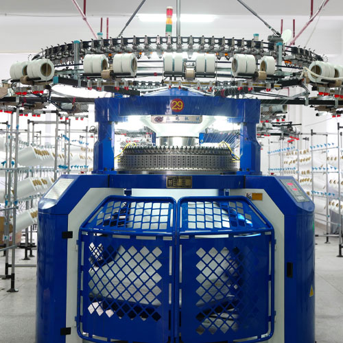 person using crane to move industrial gear box in engineering factory