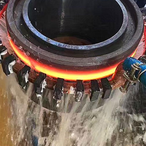 person using crane to move industrial gear box in engineering factory